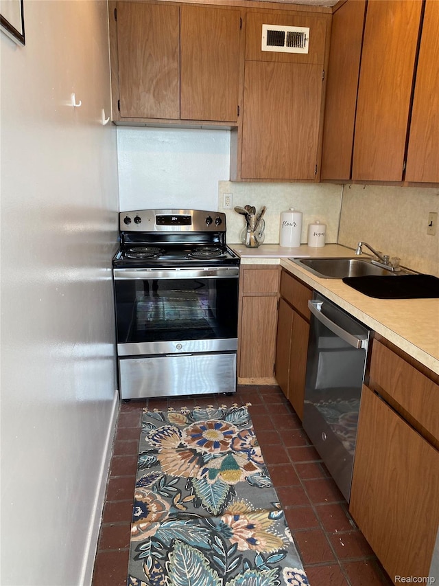 8900 E Jefferson Ave Unit 926, Detroit, MI 48214 - kitchen with appliances with stainless steel finishes, dark tile patterned floors, and light countertops