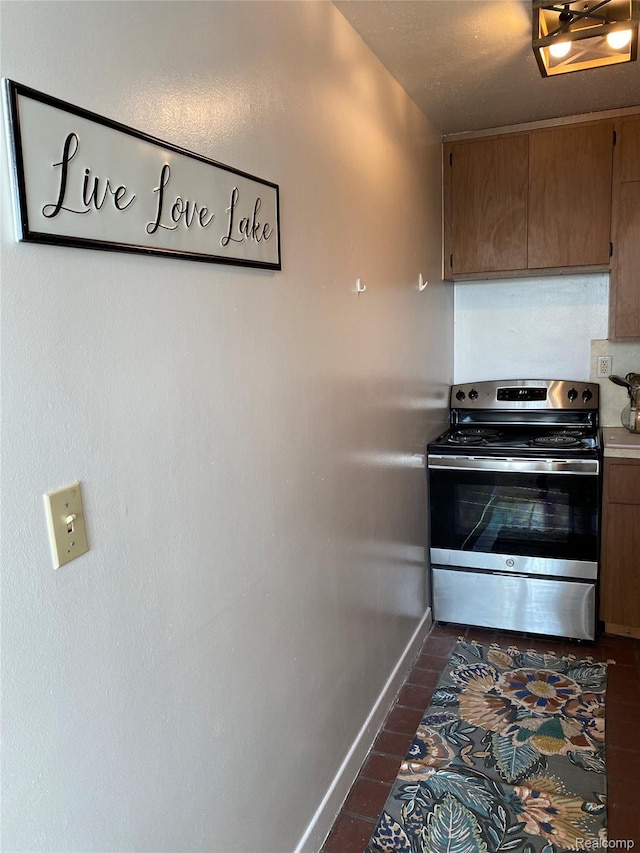 8900 E Jefferson Ave Unit 926, Detroit, MI 48214 - kitchen featuring electric range, light countertops, and dark tile patterned flooring