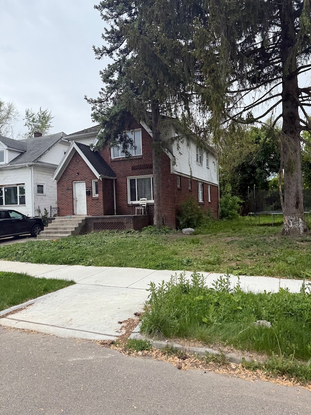 5931 Wayburn St, Detroit, MI 48224 - view of front of house featuring brick siding and a front lawn