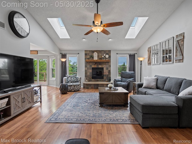6102 Cherry Ridge Dr, Howell, MI 48855 - living area featuring a skylight, plenty of natural light, a ceiling fan, a textured ceiling, and high vaulted ceiling