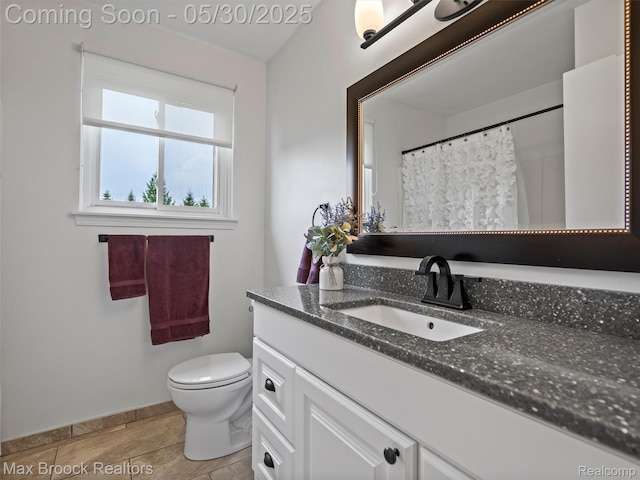6102 Cherry Ridge Dr, Howell, MI 48855 - bathroom with toilet, vanity, and baseboards