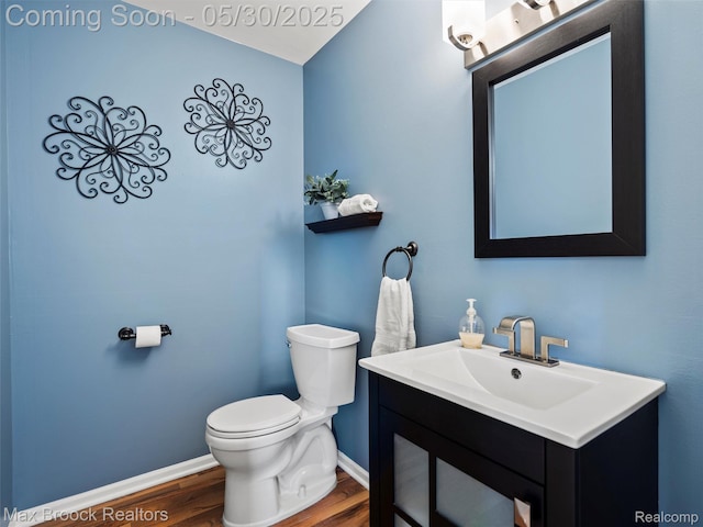 6102 Cherry Ridge Dr, Howell, MI 48855 - half bath featuring wood finished floors, baseboards, toilet, and vanity