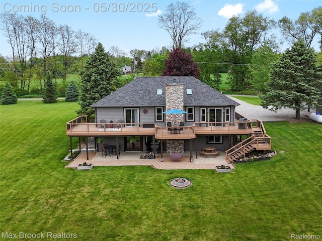 6102 Cherry Ridge Dr, Howell, MI 48855 - back of house with a fire pit, a deck, a patio, and a lawn