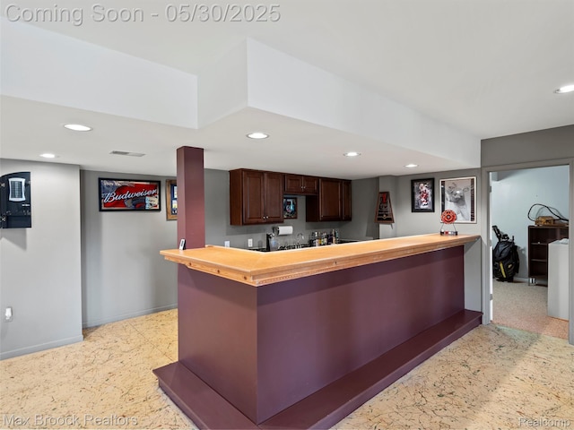 6102 Cherry Ridge Dr, Howell, MI 48855 - kitchen featuring wood counters, baseboards, recessed lighting, dark brown cabinetry, and a peninsula
