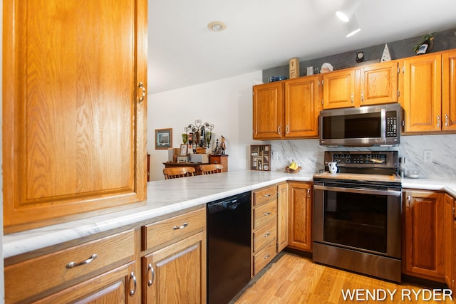 937 Village Ct, Holland, MI 49423 - kitchen with appliances with stainless steel finishes, light countertops, and decorative backsplash