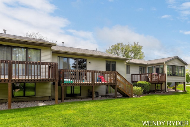 937 Village Ct, Holland, MI 49423 - back of property with a sunroom, a wooden deck, stairway, a yard, and roof with shingles