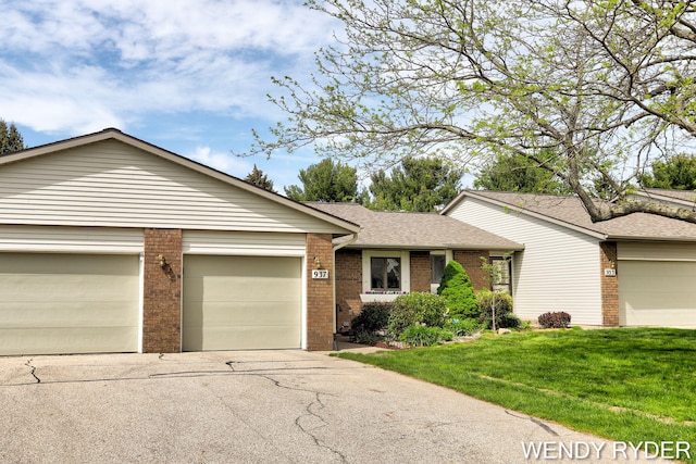 937 Village Ct, Holland, MI 49423 - ranch-style home with brick siding, concrete driveway, a front lawn, and an attached garage