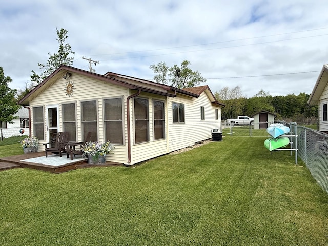 rear view of house with central AC unit and a deck