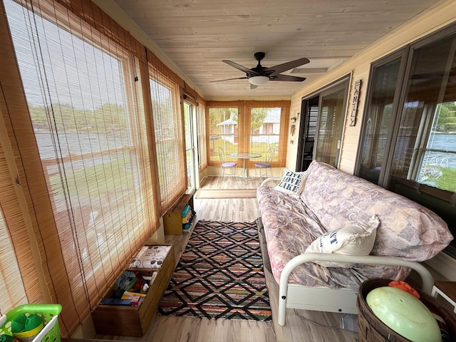 sunroom / solarium with healthy amount of natural light and a ceiling fan