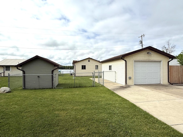 view of yard featuring a detached garage, driveway, and an outdoor structure