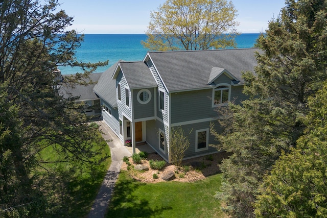3801 N Scenic Dr, Muskegon, MI 49445 - view of side of property featuring a water view, a shingled roof, and a yard