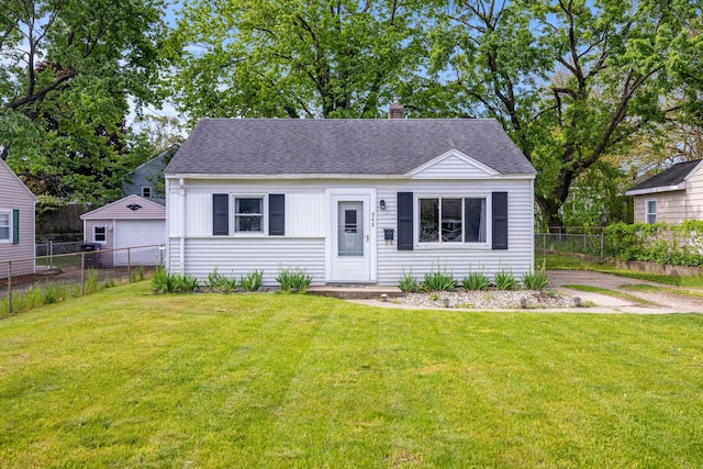 948 33rd St SW, Wyoming, MI 49509 - view of front facade featuring a chimney and a shingled roof