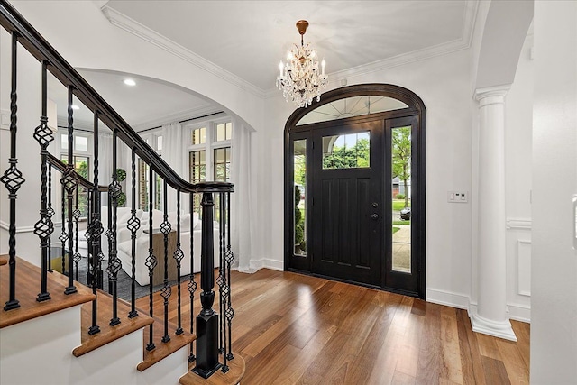 820 Hazel St, Birmingham, MI 48009 - foyer featuring arched walkways, healthy amount of natural light, wood finished floors, and ornamental molding