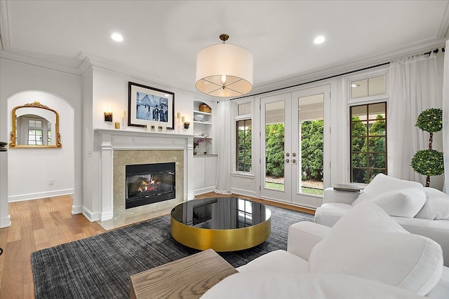 820 Hazel St, Birmingham, MI 48009 - living area with crown molding, french doors, baseboards, healthy amount of natural light, and a premium fireplace