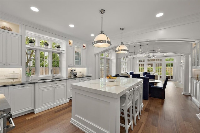 820 Hazel St, Birmingham, MI 48009 - kitchen featuring a sink, ornamental molding, white cabinets, a kitchen island, and recessed lighting
