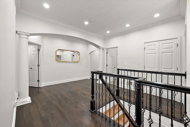 820 Hazel St, Birmingham, MI 48009 - corridor featuring decorative columns, arched walkways, dark wood finished floors, baseboards, and crown molding