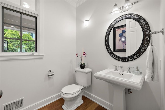 820 Hazel St, Birmingham, MI 48009 - half bath with baseboards, wood finished floors, ornamental molding, and toilet