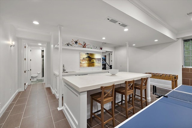 820 Hazel St, Birmingham, MI 48009 - kitchen with a sink, a breakfast bar area, recessed lighting, light countertops, and a kitchen island