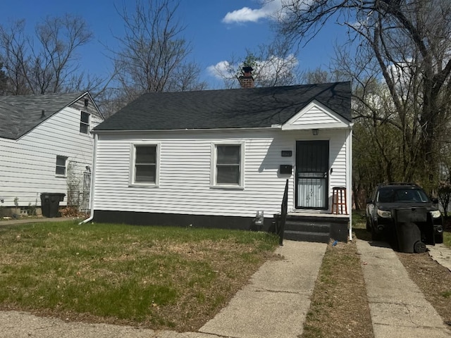 19308 Glastonbury Rd, Detroit, MI 48219 - bungalow-style home featuring a chimney, a shingled roof, and a front yard