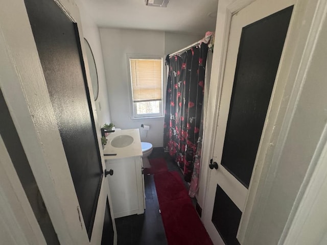 19308 Glastonbury Rd, Detroit, MI 48219 - full bathroom with vanity, toilet, and a shower with curtain