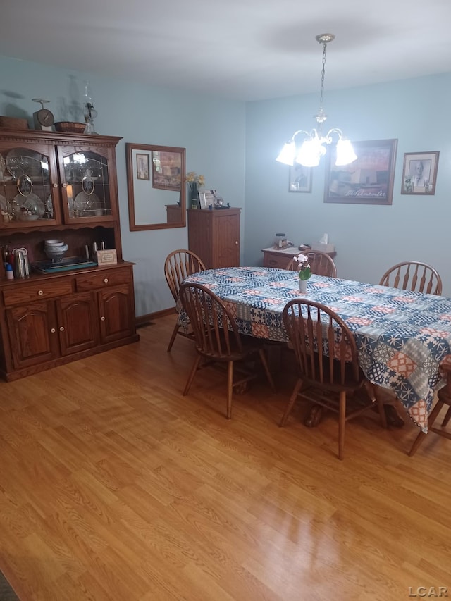 1186 Buckingham Ct, Adrian, MI 49221 - dining area featuring light wood-style floors and a chandelier