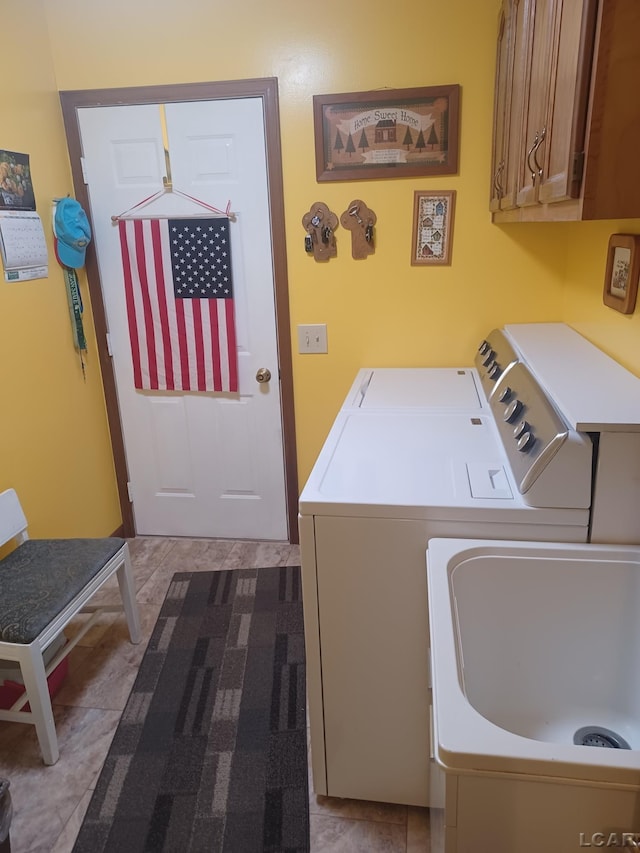 1186 Buckingham Ct, Adrian, MI 49221 - washroom with cabinet space, washing machine and dryer, and tile patterned floors