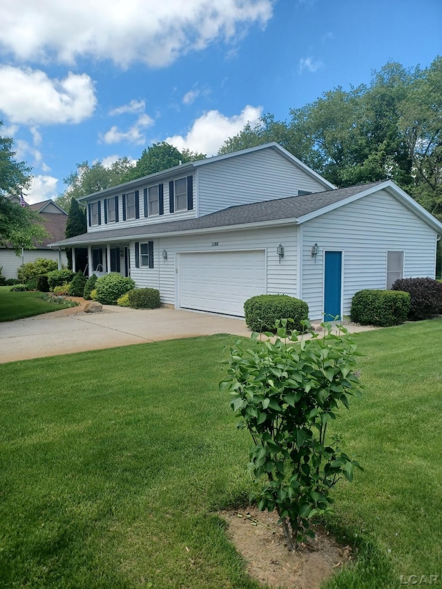 1186 Buckingham Ct, Adrian, MI 49221 - view of front facade featuring a front yard, a garage, and driveway
