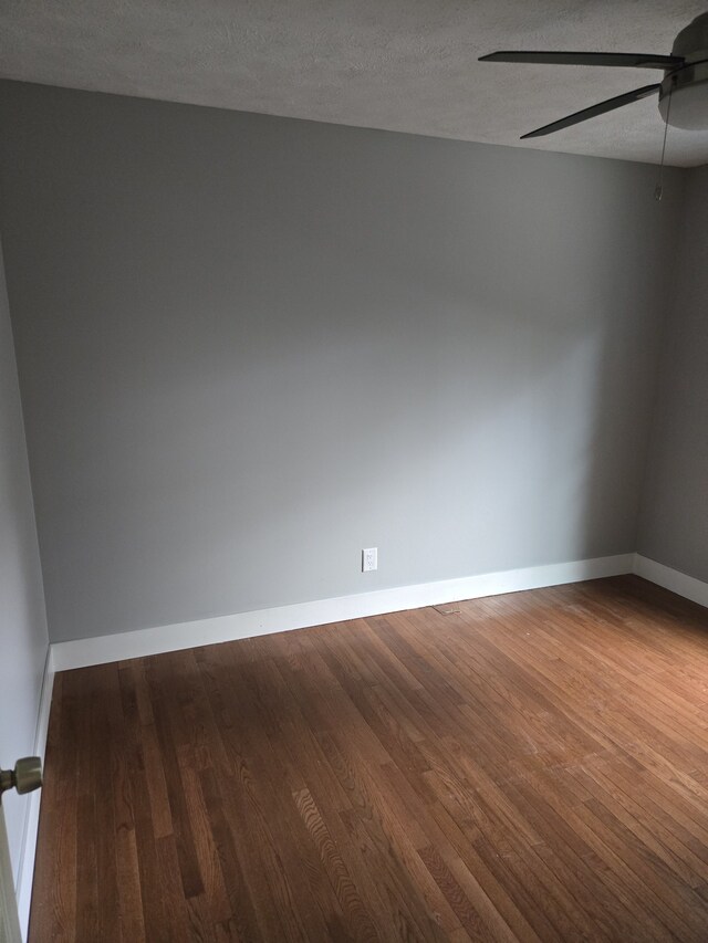 4283 Bartlett Rd, Williamsburg, MI 49690 - spare room with ceiling fan, wood finished floors, baseboards, and a textured ceiling