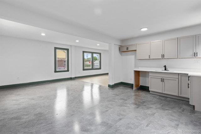15781 Washburn St, Detroit, MI 48238 - kitchen featuring gray cabinetry, a sink, recessed lighting, finished concrete floors, and baseboards