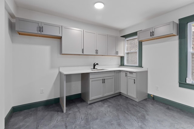 15781 Washburn St, Detroit, MI 48238 - kitchen featuring a sink, gray cabinets, baseboards, and light countertops
