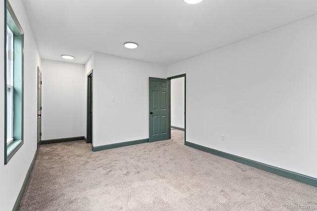 15781 Washburn St, Detroit, MI 48238 - spare room featuring light carpet and baseboards