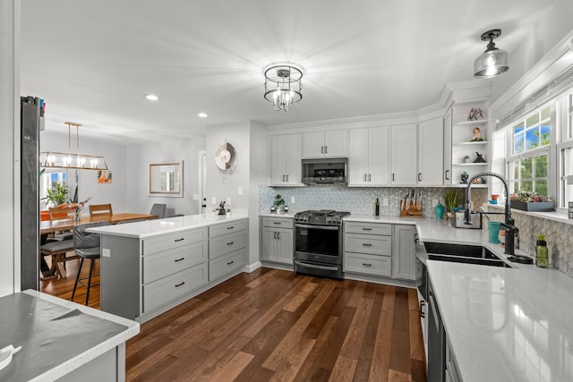 1600 Tuttle Rd, Mason, MI 48854 - kitchen with appliances with stainless steel finishes, a chandelier, backsplash, and recessed lighting
