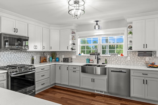 1600 Tuttle Rd, Mason, MI 48854 - kitchen with stainless steel appliances, open shelves, a sink, backsplash, and gray cabinetry