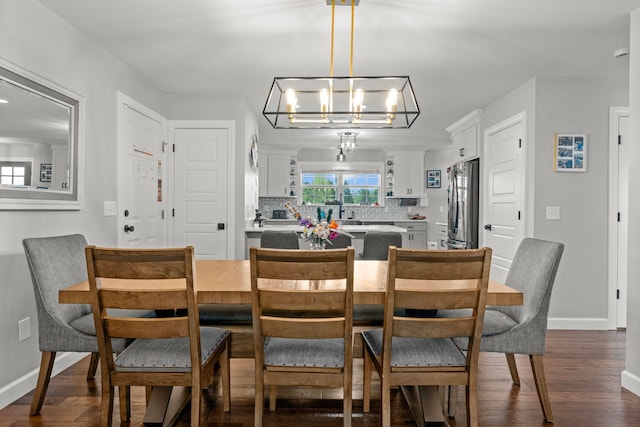 1600 Tuttle Rd, Mason, MI 48854 - dining room with dark wood-style floors, a chandelier, and baseboards