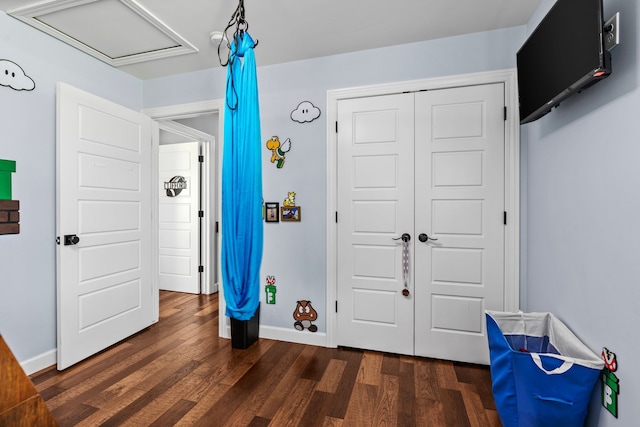 1600 Tuttle Rd, Mason, MI 48854 - recreation room with dark wood finished floors, baseboards, and attic access