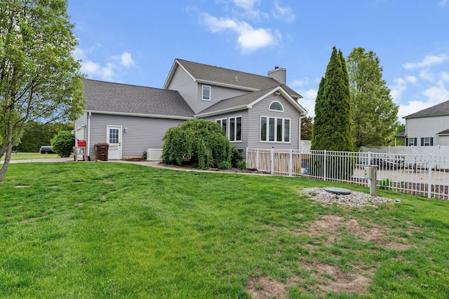 1600 Tuttle Rd, Mason, MI 48854 - rear view of house featuring a chimney and roof with shingles