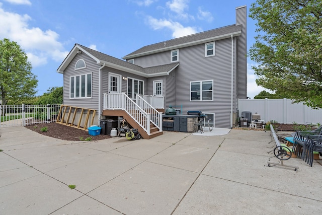 1600 Tuttle Rd, Mason, MI 48854 - back of house with a chimney, a patio, and central air condition unit
