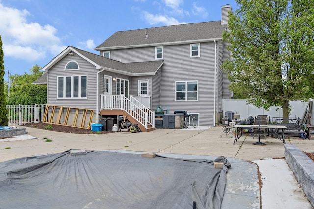 1600 Tuttle Rd, Mason, MI 48854 - rear view of house with a patio, a chimney, and roof with shingles