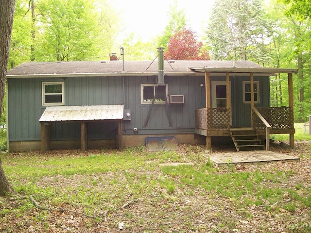 5300 State Rd, Hillsdale, MI 49242 - rear view of property featuring a wooden deck, roof with shingles, a chimney, and board and batten siding