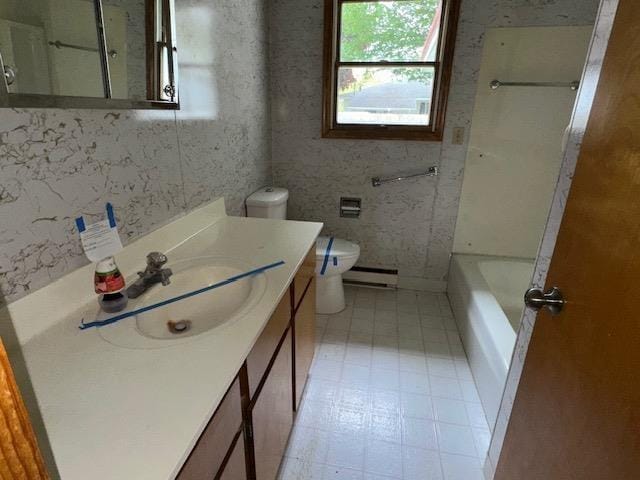 175 S Hudnut, Barryton, MI 49305 - full bathroom featuring vanity, a baseboard radiator, and toilet