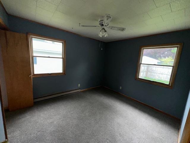 175 S Hudnut, Barryton, MI 49305 - unfurnished room featuring a baseboard heating unit, a ceiling fan, carpet floors, and baseboards