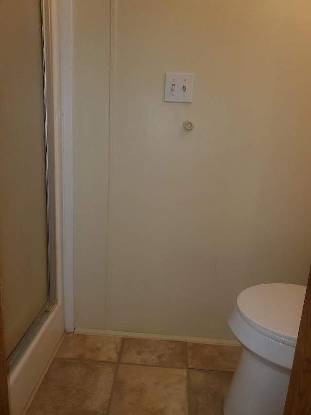 5232 E Broadway, Mount Pleasant, MI 48858 - bathroom with toilet, baseboards, and tile patterned floors