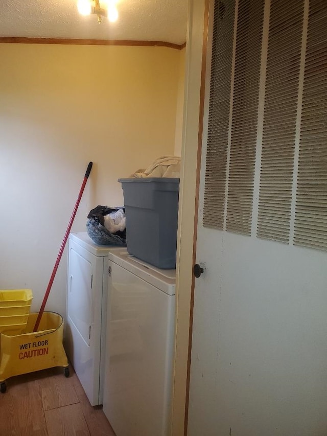 5232 E Broadway, Mount Pleasant, MI 48858 - clothes washing area with a heating unit, independent washer and dryer, wood finished floors, and ornamental molding