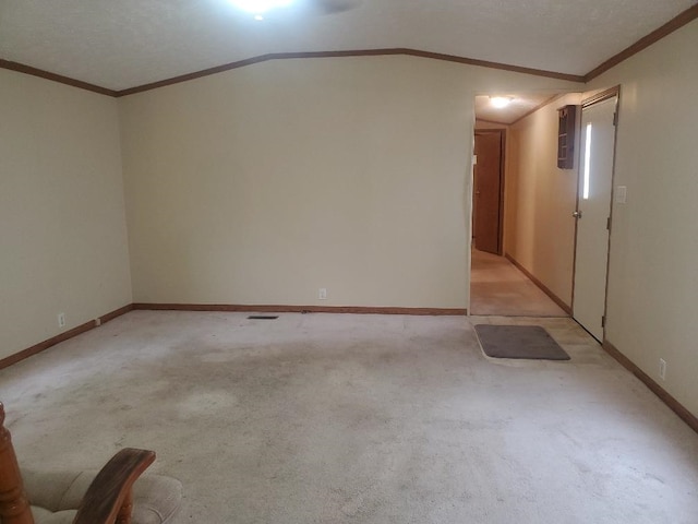 5232 E Broadway, Mount Pleasant, MI 48858 - spare room with ornamental molding, light carpet, lofted ceiling, and baseboards