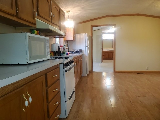 5232 E Broadway, Mount Pleasant, MI 48858 - kitchen with white appliances, under cabinet range hood, brown cabinets, ornamental molding, and light wood finished floors
