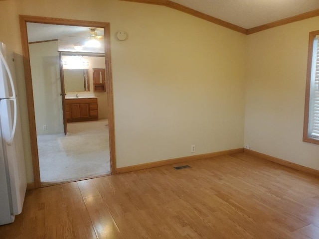 5232 E Broadway, Mount Pleasant, MI 48858 - unfurnished room featuring light wood-style flooring, ornamental molding, a smoke detector, a sink, and lofted ceiling