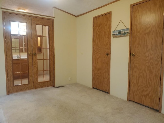 5232 E Broadway, Mount Pleasant, MI 48858 - carpeted empty room featuring crown molding, french doors, and a sink