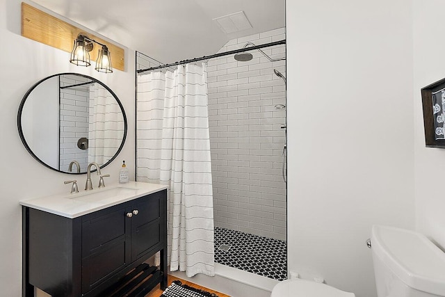 8282 W Harrison Rd, Mears, MI 49436 - bathroom featuring toilet, a stall shower, and vanity