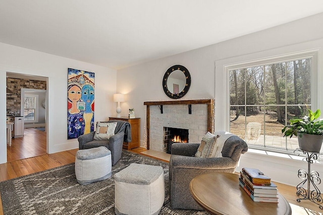 8282 W Harrison Rd, Mears, MI 49436 - living area featuring a fireplace and light wood-type flooring