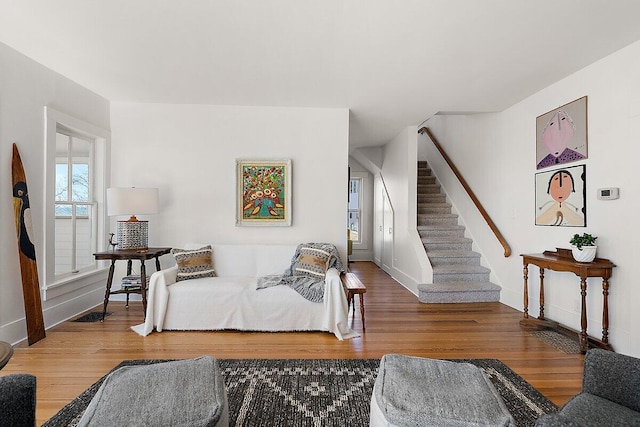 8282 W Harrison Rd, Mears, MI 49436 - living area with stairway, wood finished floors, and baseboards